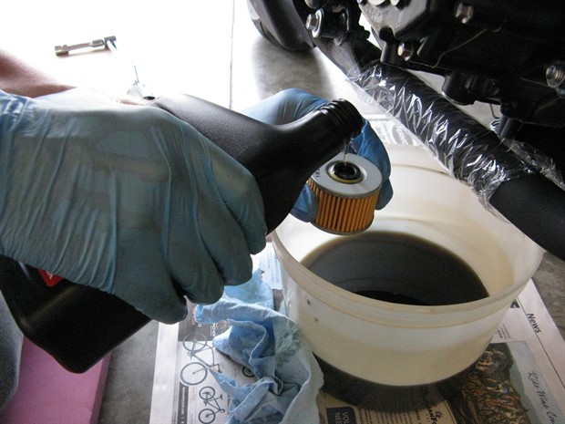 Pouring oil into new oil filter, 2012 Honda CBR250RA