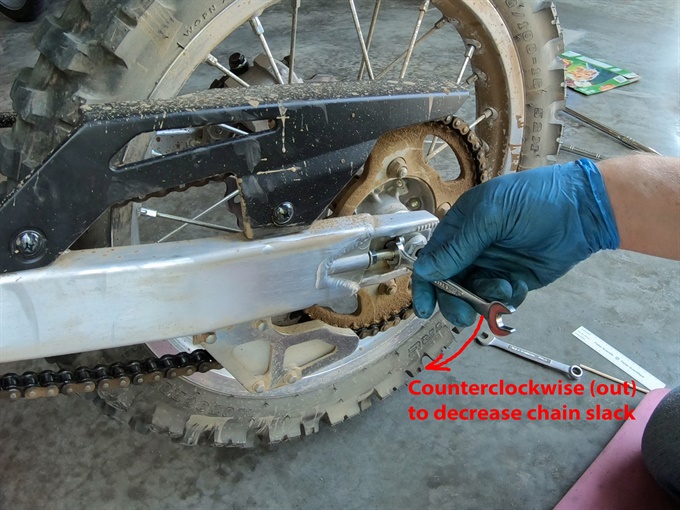 Turning adjuster bolt outwards (counterclockwise) - KLX140L