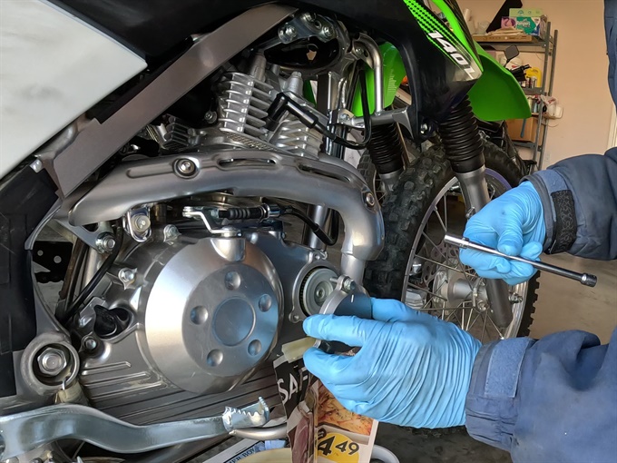 Removing oil filter cover- KLX140L