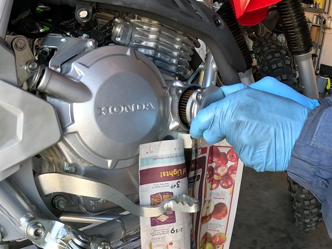 Removing the oil filter cover and oil filter - CRF250F