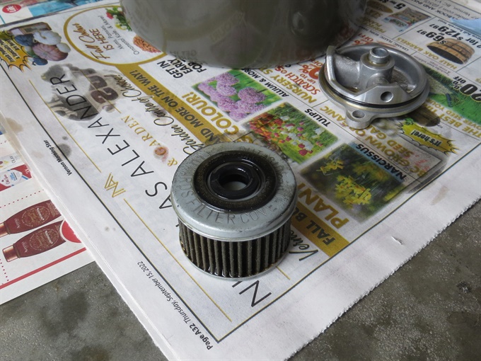 Dirty oil filter with Motion Pro oil filter magnet and oil filter cover - CRF250F