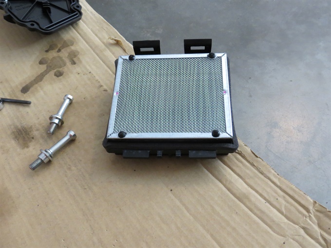 CRF300L air filter - the 4 tabs on the air filter (towards bottom of image) go into back of air box. Seat bolts with spacers also shown.