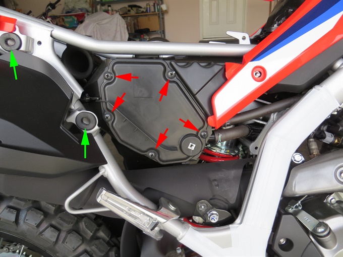 CRF300L air box. Red arrows = screws for air box cover, green arrows = grommets.