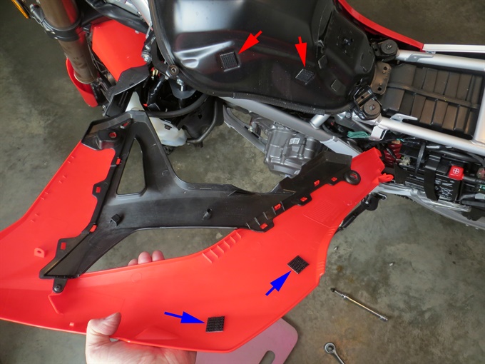 CRF300L - left tank shroud removed. Arrows indicate dual-lock fasteners.