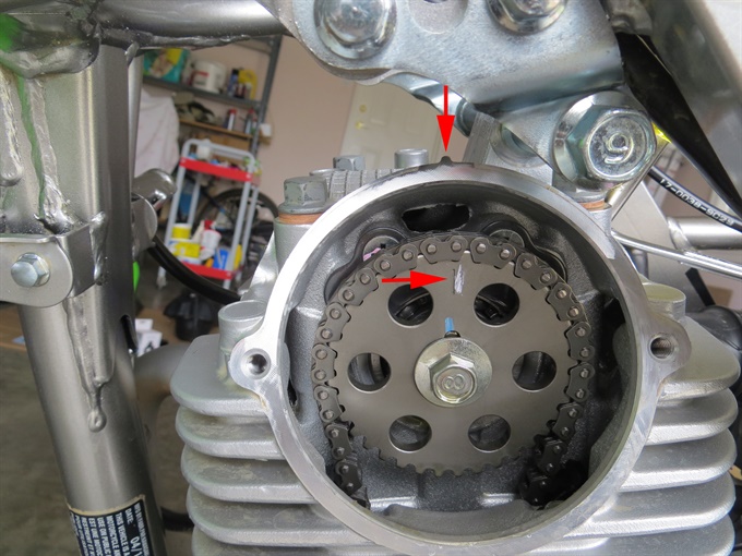 Camshaft sprocket mark and the mark (bump) on the cylinder head (the marks are misaligned just a bit in the photo) - KLX140