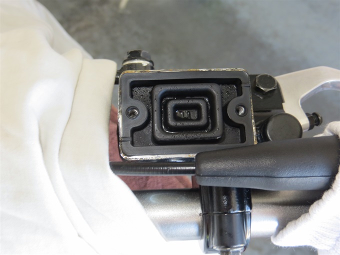 KLX140 front master cylinder with cap removed and diaphragm in place.