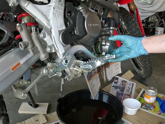 Removing the oil filter cover, 2023 Honda CRF300L