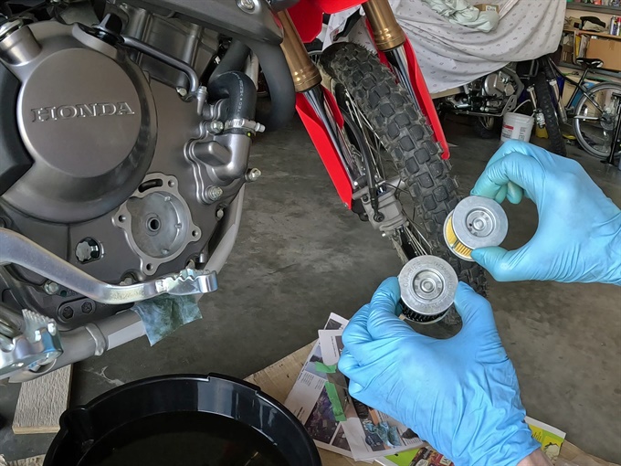 Comparing new OEM oil filter to old one, 2023 Honda CRF300L