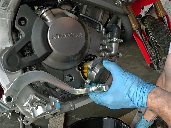 Installing the oil filter cover with gasket and spring, 2023 Honda CRF300L