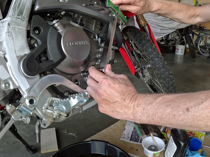 Using a torque wrench for final tightening of the oil filter cover bolts, 2023 Honda CRF300L