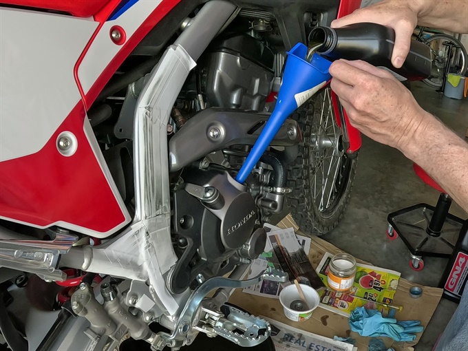 Pouring fresh oil into the engine, 2023 Honda CRF300L