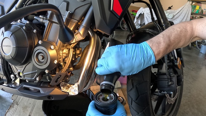 Pouring oil into the new oil filter, 2024 Honda NX500