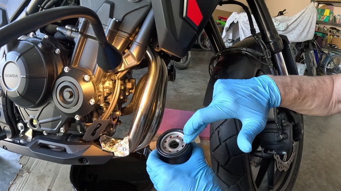 Applying engine oil to the O-ring (and threads) of the new oil filter, 2024 Honda NX500