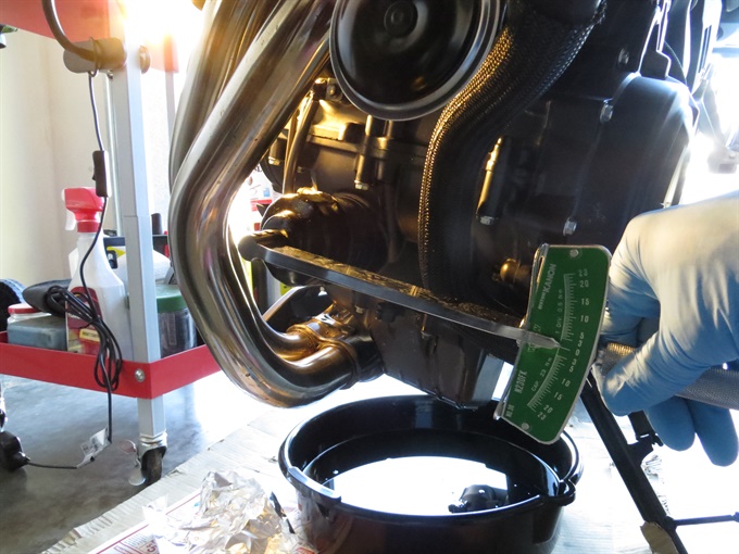 Tightening the new oil filter with a torque wrench, 2024 Honda NX500