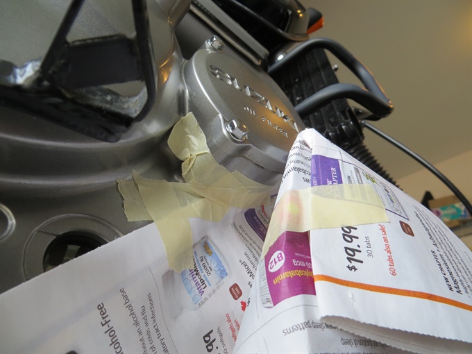 Newspaper taped to engine to limit mess - DR650SE